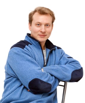 Portrait men blond sits on chair on gray background