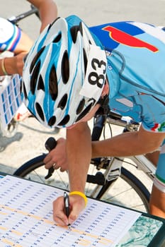 The cyclists riding by at the bicycle race