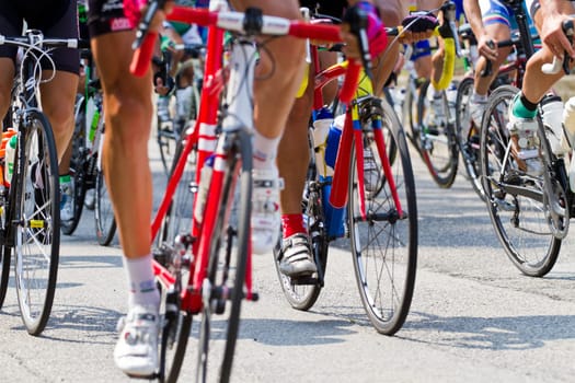 The cyclists riding by at the bicycle race