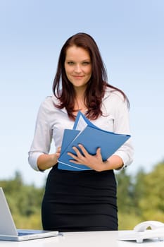 Young businesswoman in sunny nature attractive smiling hold folders