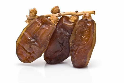 Date fruit isolated over a white background.