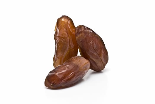 Date fruit isolated over a white background.
