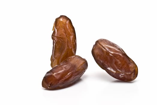 Date fruit isolated over a white background.