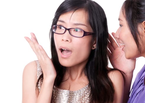 Girl telling a secret to another - gossip isolated over a white background