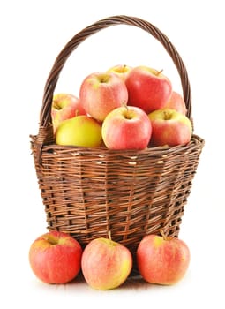 Composition with apples in wicker basket isolated on white