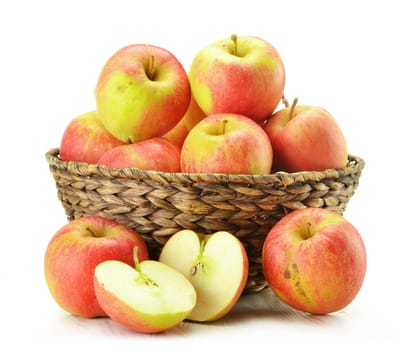 Composition with apples in wicker basket isolated on white