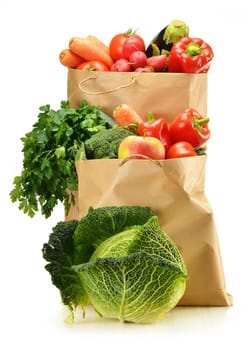 Composition with raw vegetables and shopping bag isolated on white