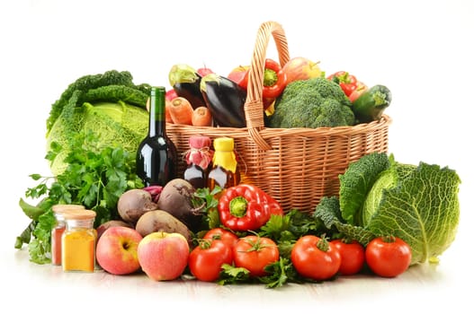 Composition with raw vegetables and wicker basket isolated on white