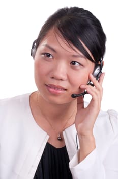 Young asian receptionist talking on hands free headset to customer isolated
