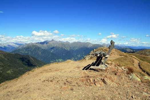 Wooden bench on a mountain peak in South Tyrol