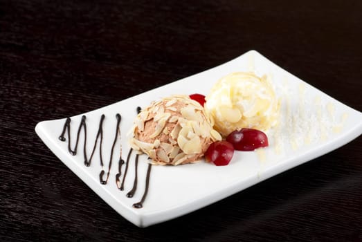 Dessert set of ice-cream with almond, chocolate and grapes