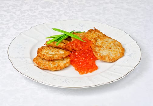 pancakes with red caviar and green onion closeup dish
