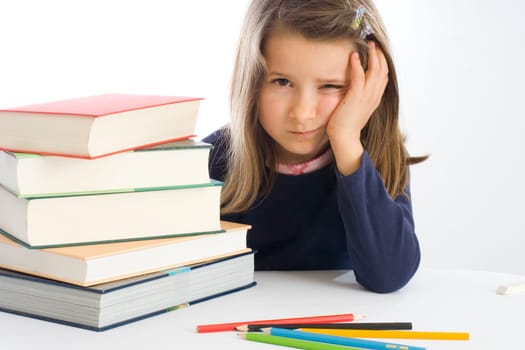 Six-year-old girl sits listlessly next to books (mr)