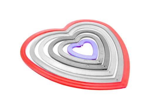 six heart shaped plastic pieces one inside the other on a white background