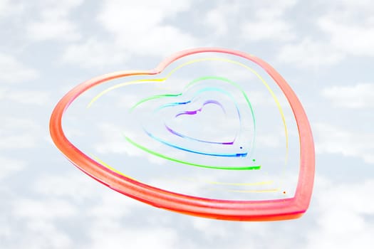 six heart shaped plastic pieces one inside the other on a cloudy background as if floating on air