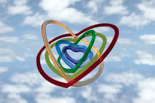 six heart shaped plastic pieces one inside the other on a cloudy background as if floating on air