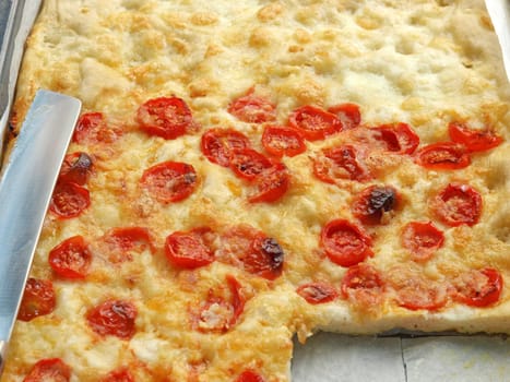 Italian Pizza with tomato topping useful as a background