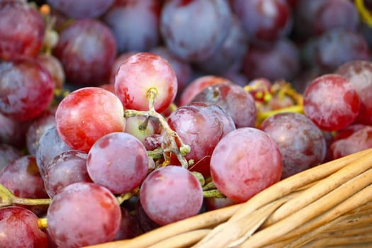 Ripe red grapes in a woven basket