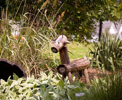 Rustic horse or deer made from tree branches in flower garden