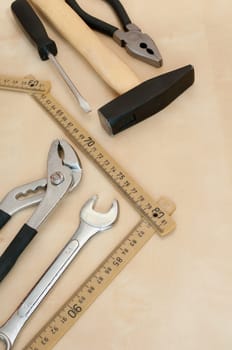 Set of Tools(Hammer, Screwdriver, Pliers, Spanner, Folding Rule) on Wooden Background With Copyspace