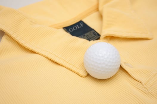 Golf Ball on Yellow Polo Shirt With Golf Sign on Tag
