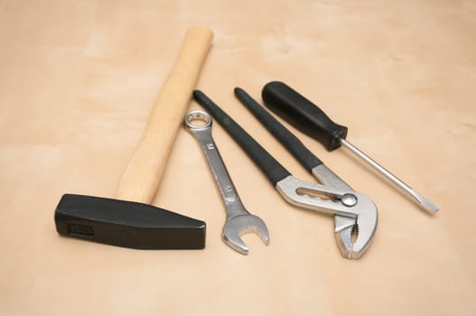 Set of Tools(Hammer, Screwdriver, Pliers, Spanner) on Wooden Background With Copyspace - Shallow Depth of Field