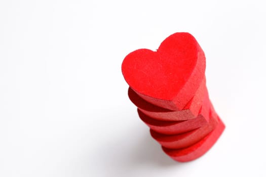 Red wooden hearts on a white background