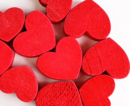 Red wooden hearts on a white background