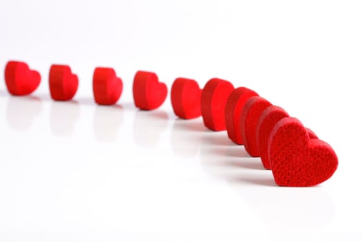 Red wooden hearts on a white background