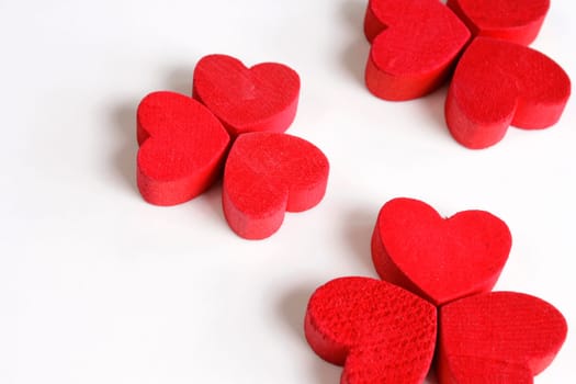 Red wooden hearts on a white background