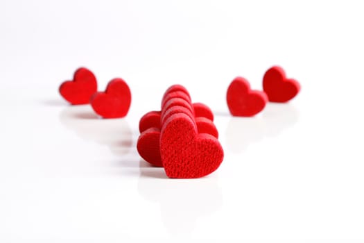 Red wooden hearts on a white background