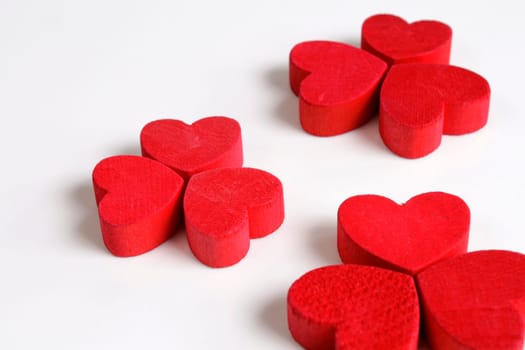 Red wooden hearts on a white background