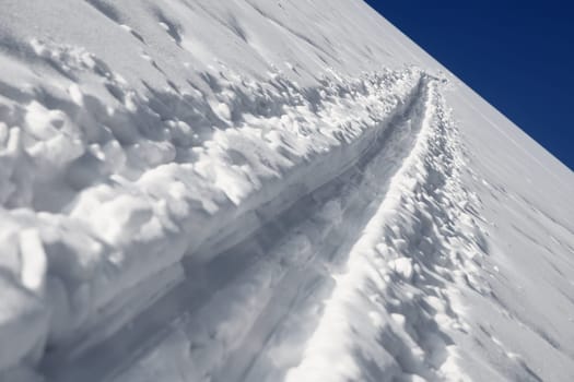 printed from the ski trail in the white snow with blue sky