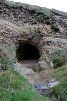 the entrance to a cave on the coast of ireland in ballybunion county kerry