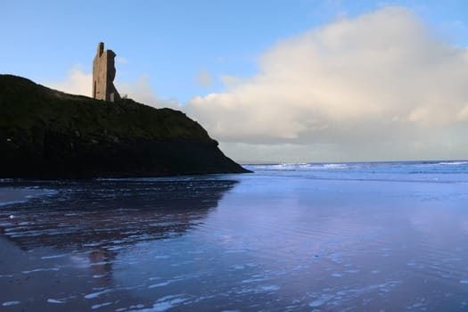 a view of the castle overlooking the beach in ballybunion co kerry ireland