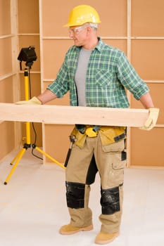 Handyman home improvement carpenter mature professional carry wooden beam