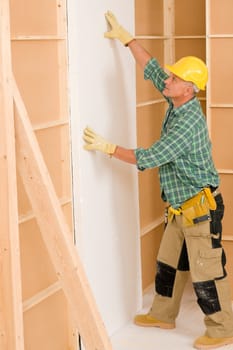 Mature handyman working on home renovations improvement isolating door