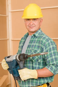 Handyman mature home improvement working with jackhammer diy