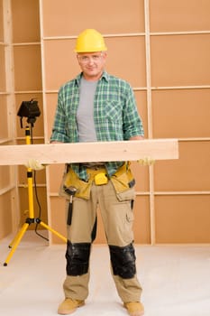 Handyman home improvement carpenter mature professional carry wooden beam