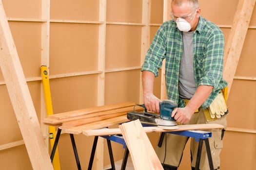 Handyman mature professional sanding wooden board diy new home renovation