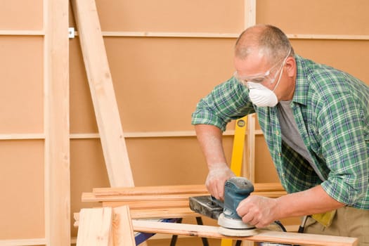 Handyman mature professional sanding wooden board diy new home renovation