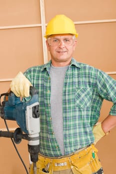 Handyman mature home improvement working with jackhammer diy