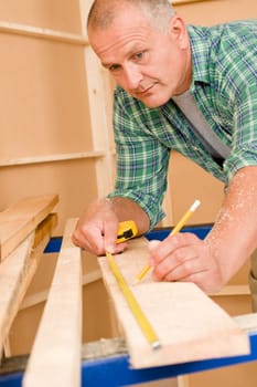 Handyman home improvement close-up of measure wooden board with ruler