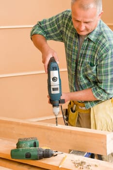 Handyman mature home improvement drilling wood