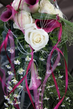 White roses and purple Callas decorated with beautiful, matching loops - upright format