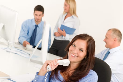 Business team pretty businesswoman holding phone happy colleagues around table
