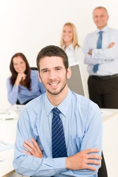 Business team portrait of handsome businessman with attractive happy colleagues