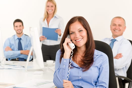 Business team pretty businesswoman calling phone happy colleagues around table
