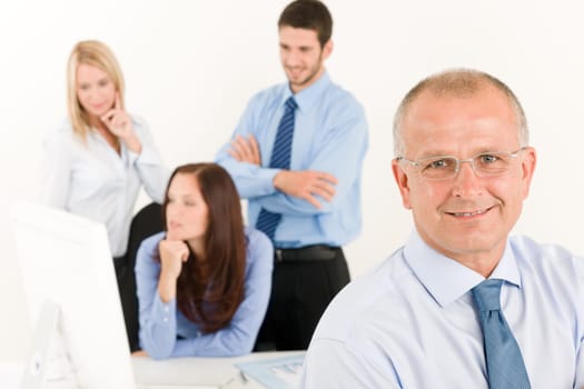 Business team close-up of senior businessman with attractive happy colleagues
