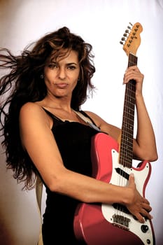 Female rock star with guitar playing